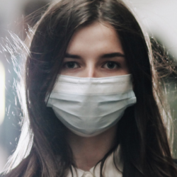 Image of a woman wearing a facemask in a crowd